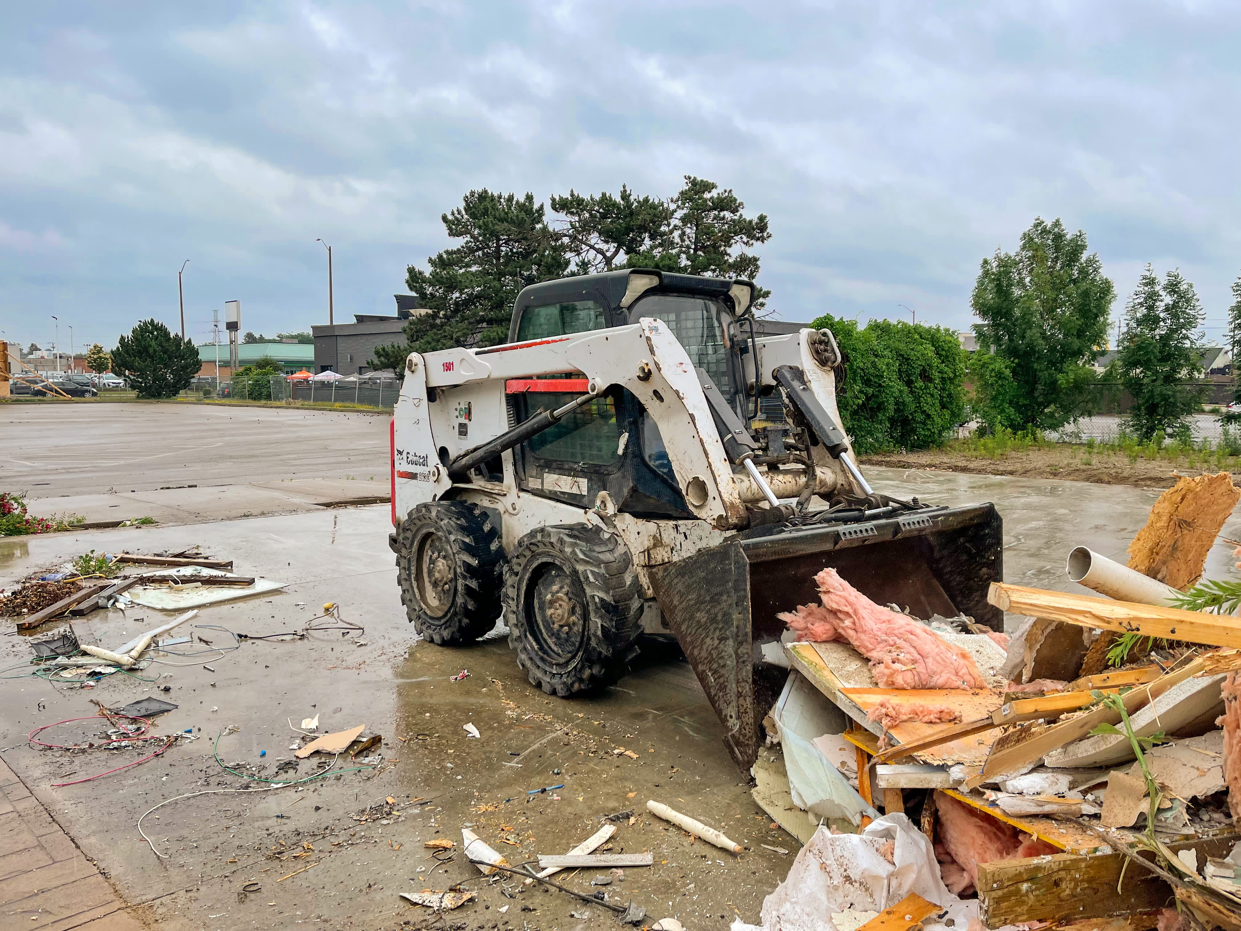 wheeled skid steer clearing hurricane debris